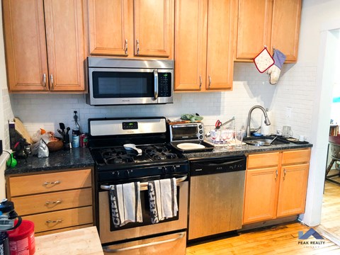 a kitchen with stainless steel appliances and wooden cabinets