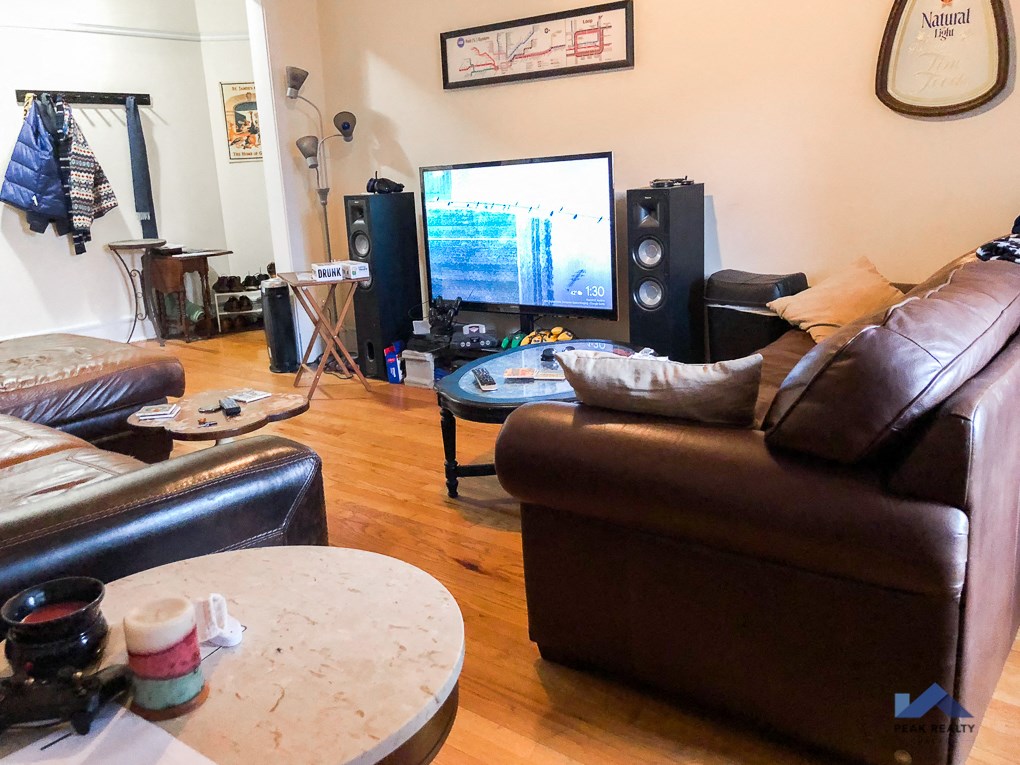 a living room with leather furniture and a tv