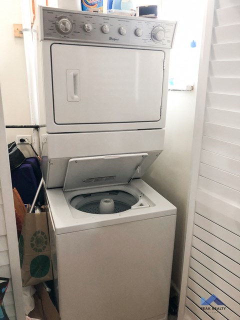 the washer and dryer are stacked on top of a washing machine