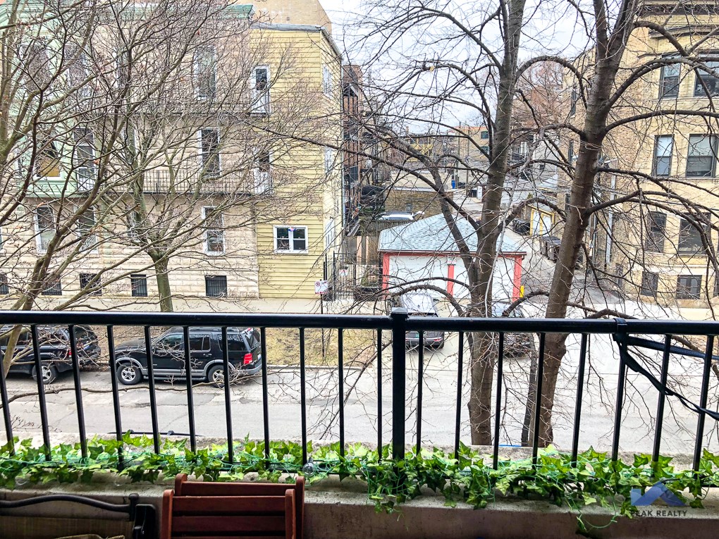 a bench on a balcony overlooking a city street