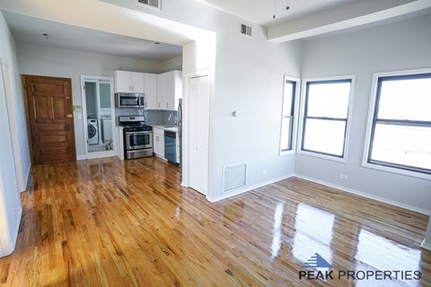 A kitchen with wooden floors and white walls.