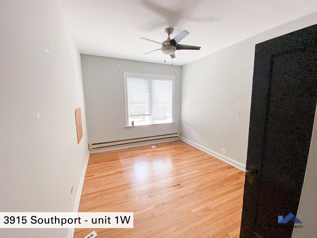a room with wood floors and a ceiling fan