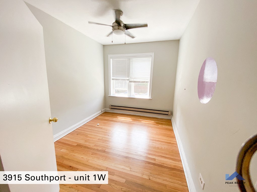 a room with wood floors and a ceiling fan