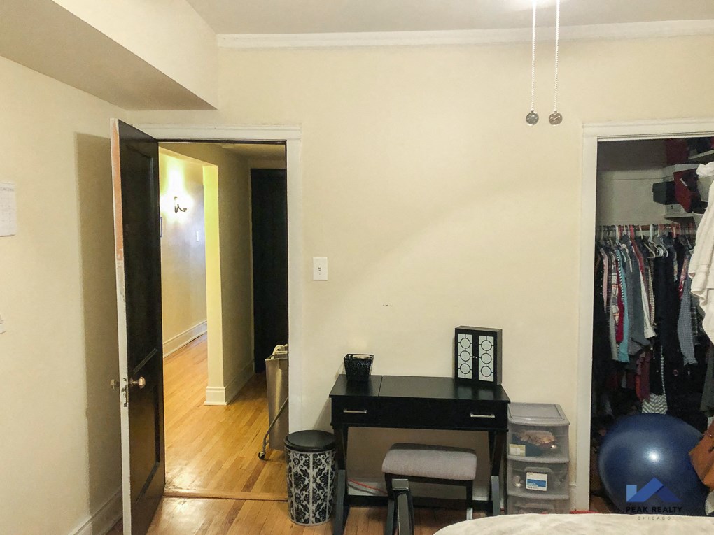 a bedroom with a desk and a closet