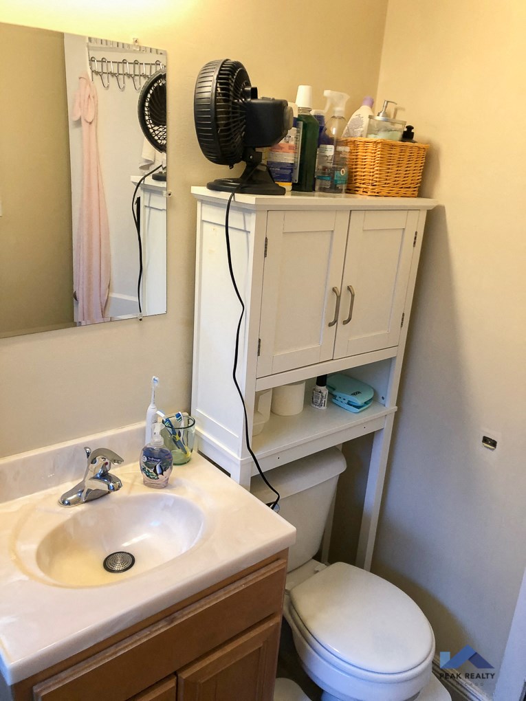 a small bathroom with a sink toilet and mirror