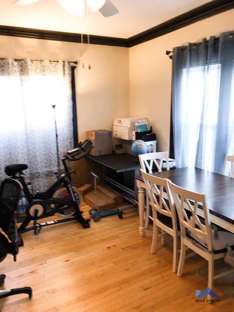 a dining room with a table and chairs and a bike in the corner