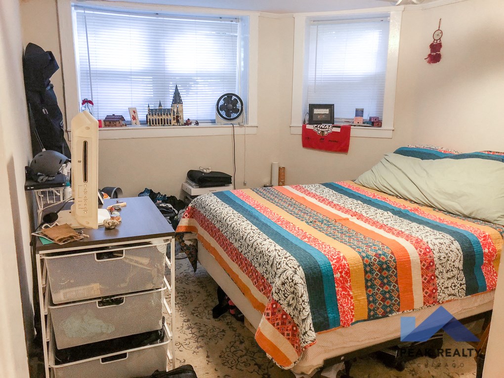 a bedroom with a bed and a dresser