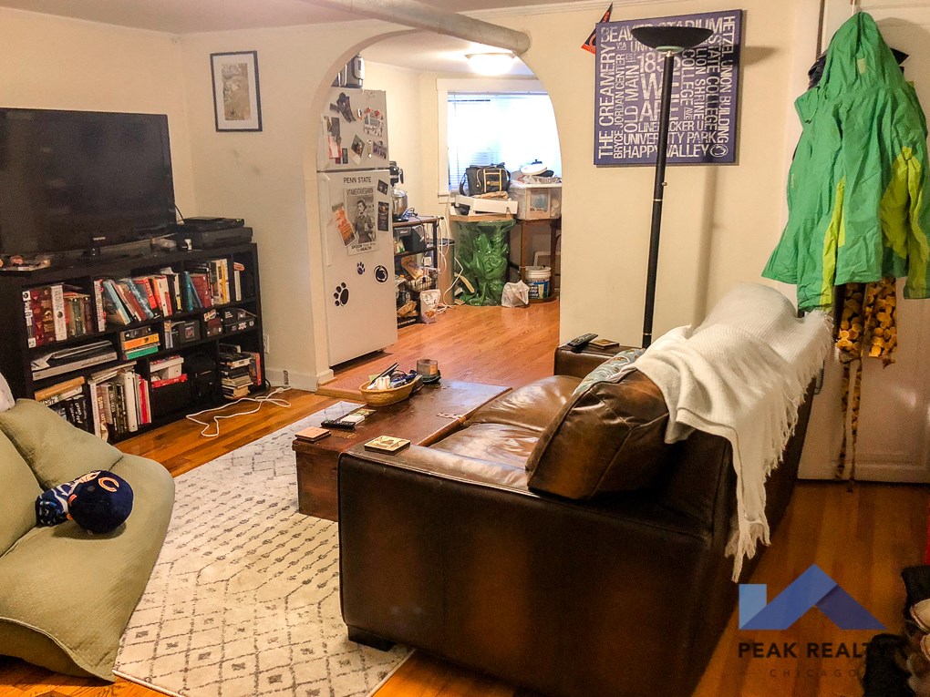 a living room with a leather couch and a tv