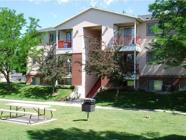 Apartment building with a green lawn in front.