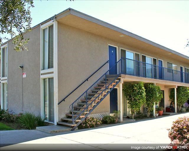 a building with a staircase and a blue door