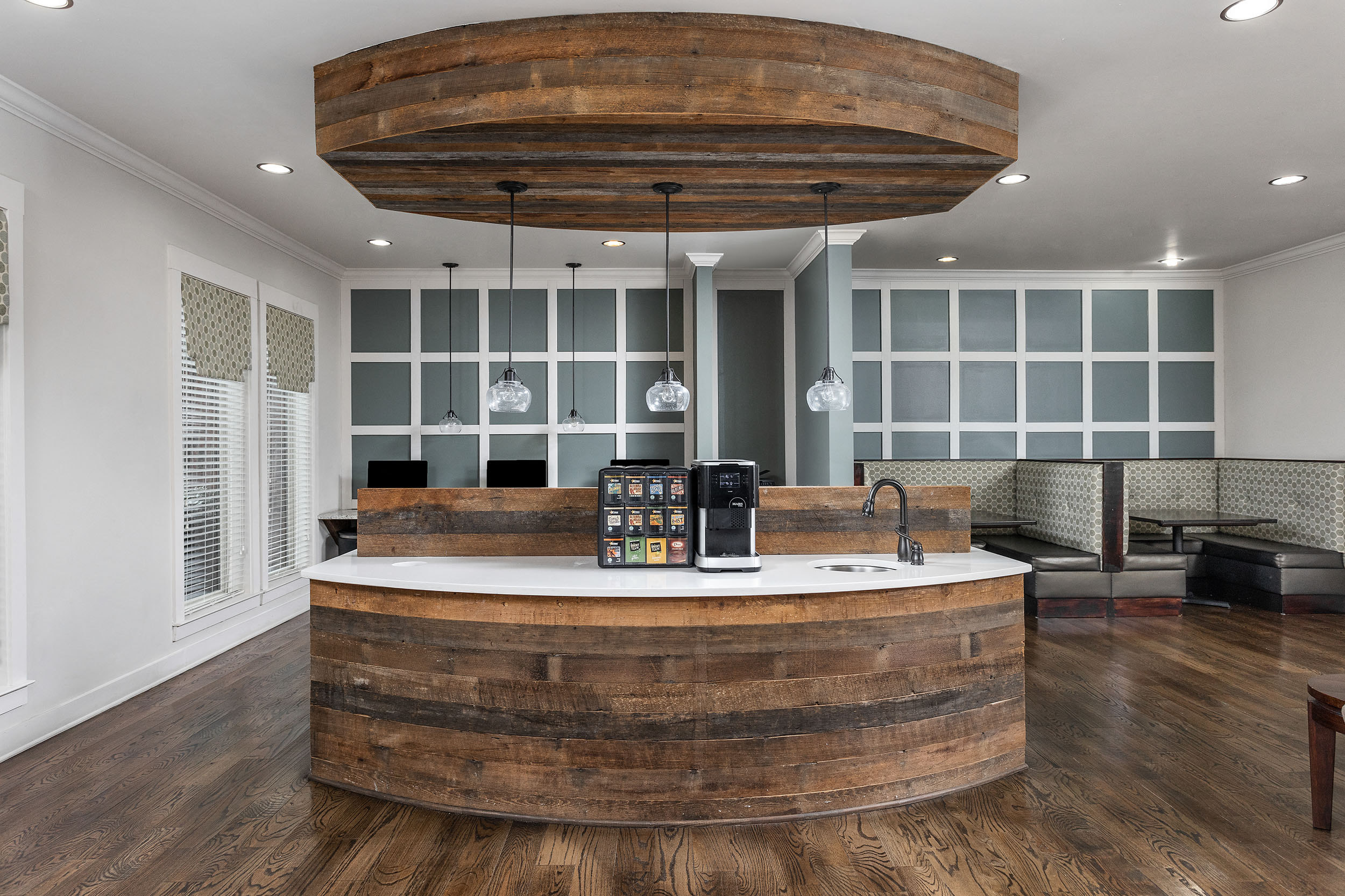 A wooden barrel shaped counter in a modern kitchen.