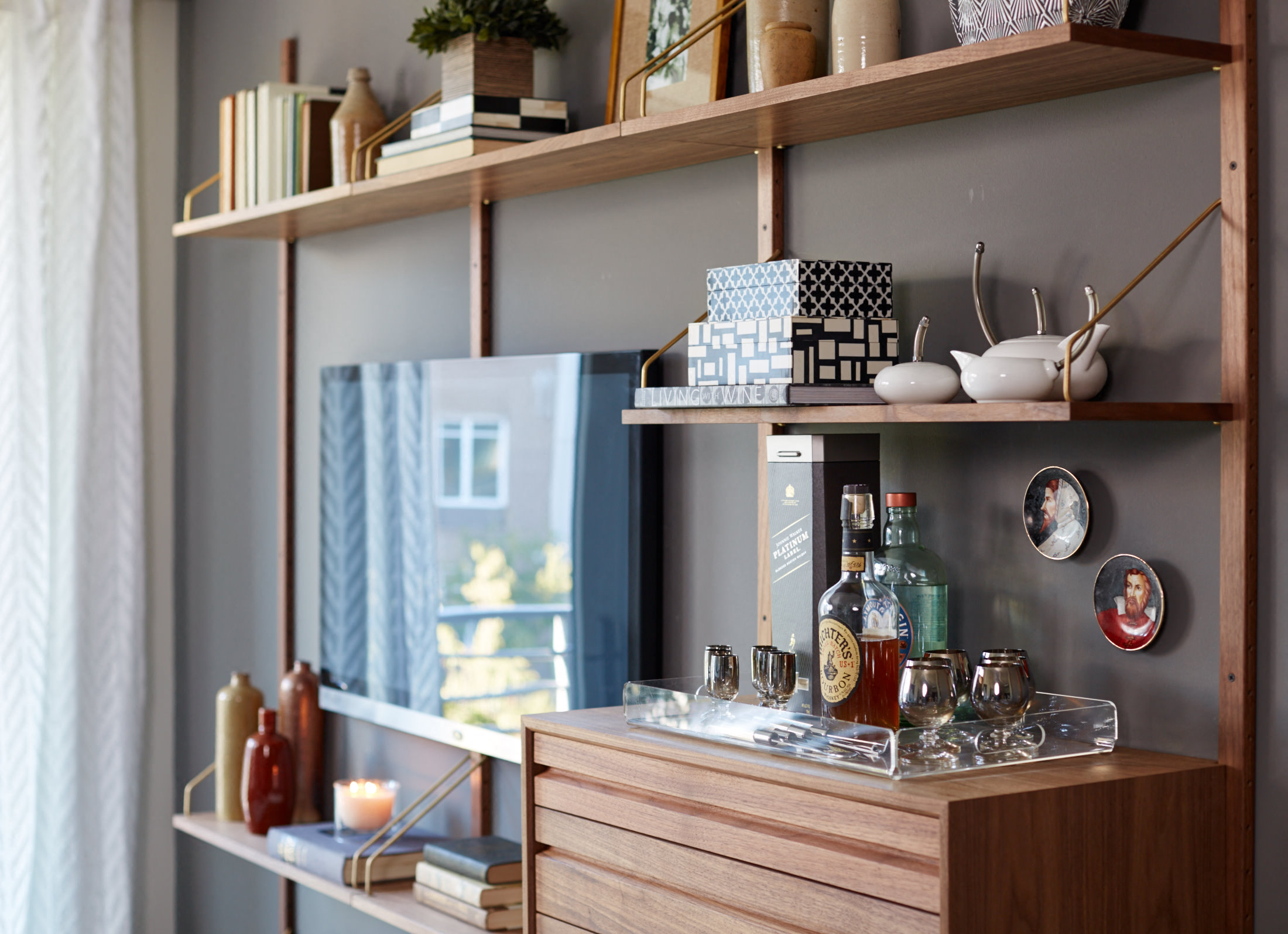 a shelf with a bottle of whiskey and other items on it