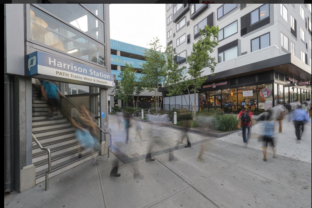people walking down the street in front of a building