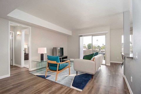 a living room with a couch and a chair and a television