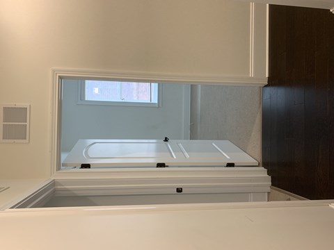 a bath room with a bath tub in a window