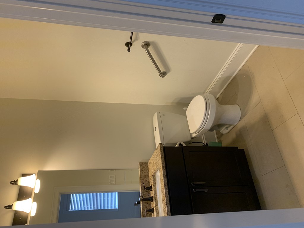 the ceiling of a bathroom with a toilet and a sink