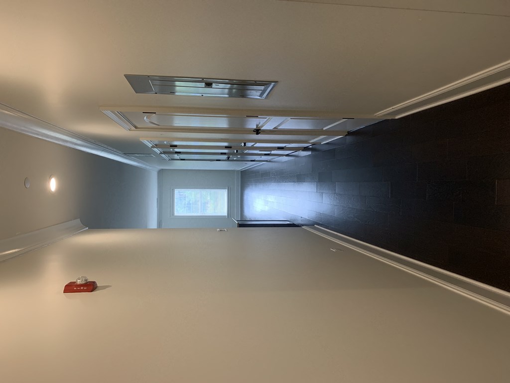 a large empty room with a red shoe on the floor