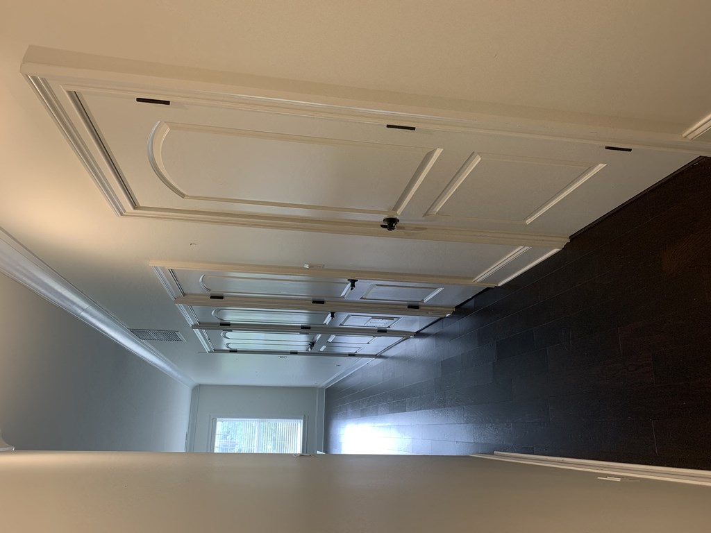 an empty room with a black wall and a white ceiling