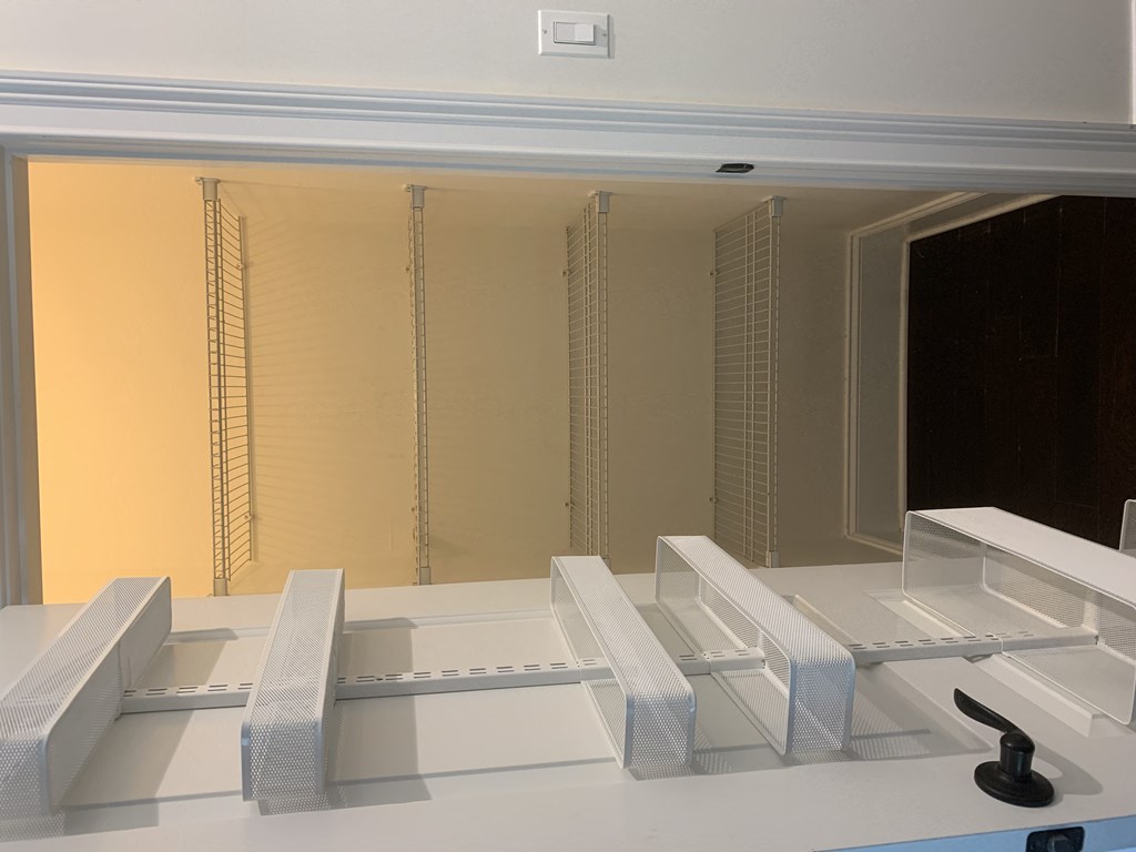 a model of a white room with white benches and a window