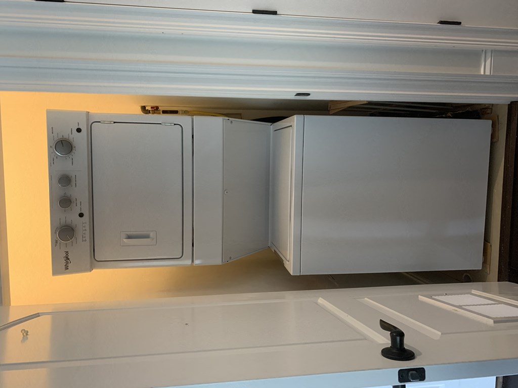 a kitchen with a refrigerator and a microwave in it