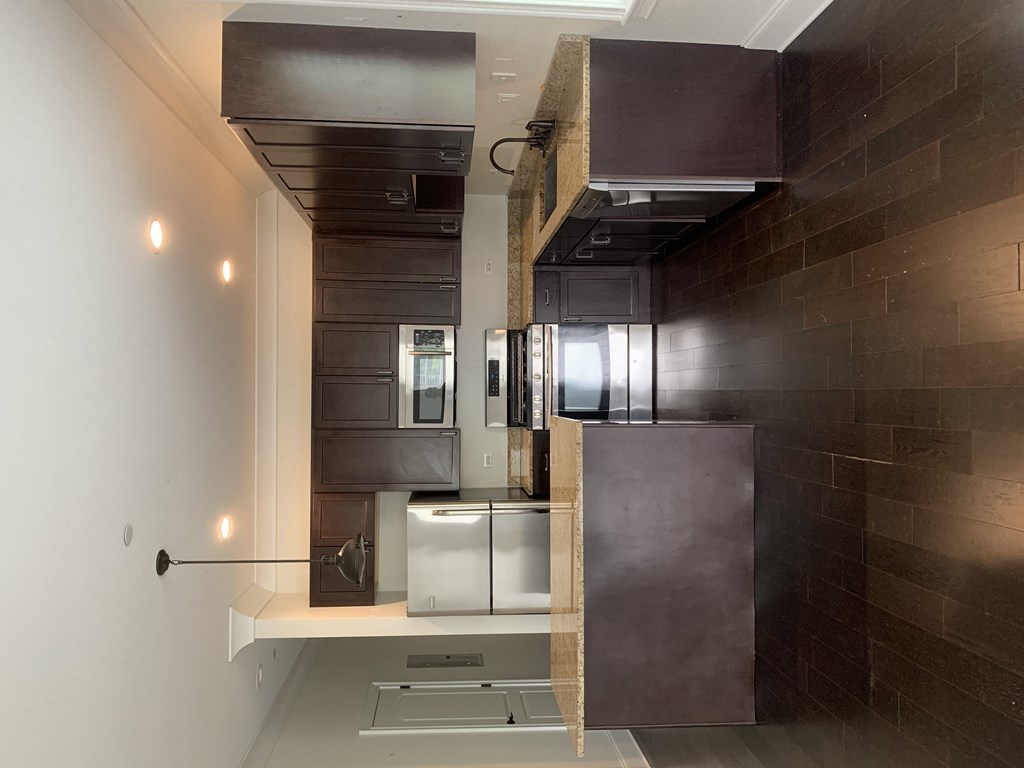 a small kitchen with a stainless steel refrigerator and a counter top