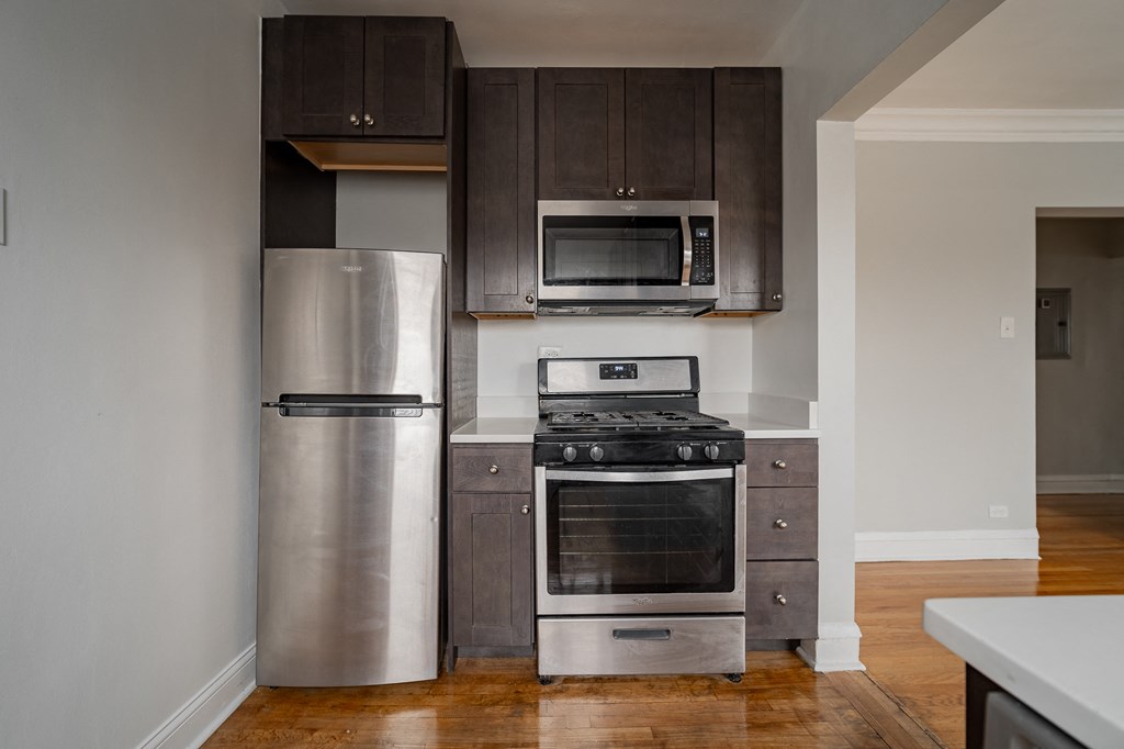 a kitchen with stainless steel appliances and wooden cabinets