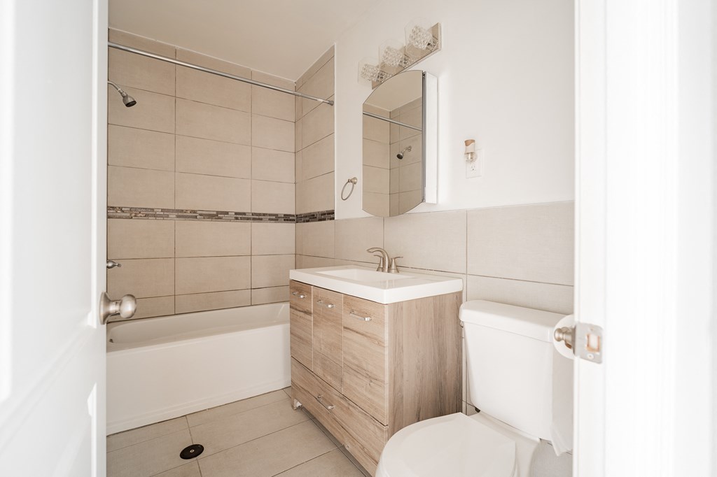 a bathroom with a sink toilet and a tub