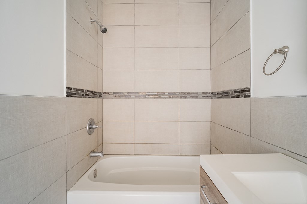 an empty bathroom with a tub and a sink