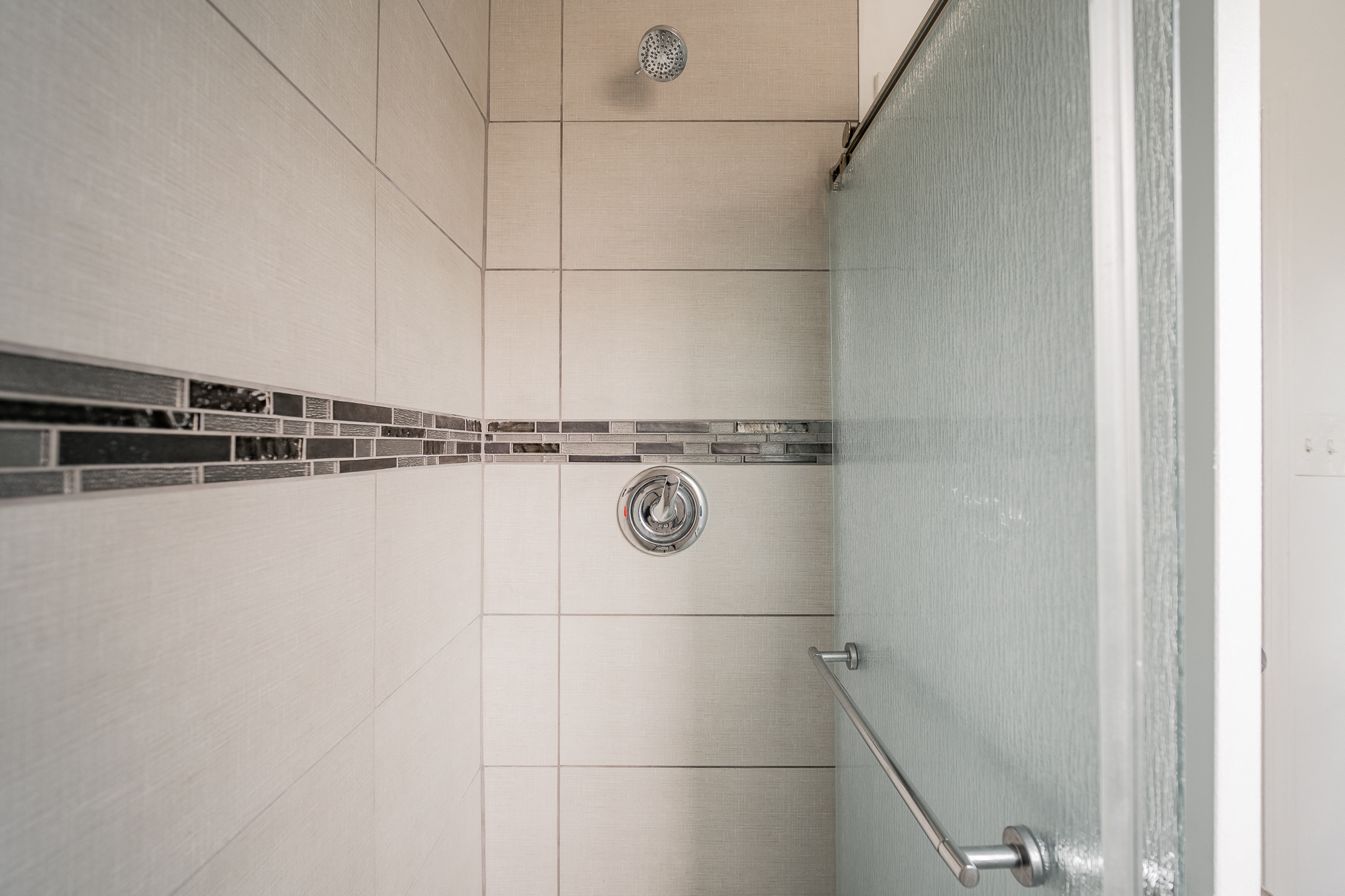 a shower in a bathroom with a glass door