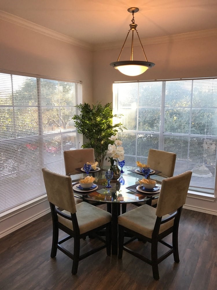a dining room with a table and chairs