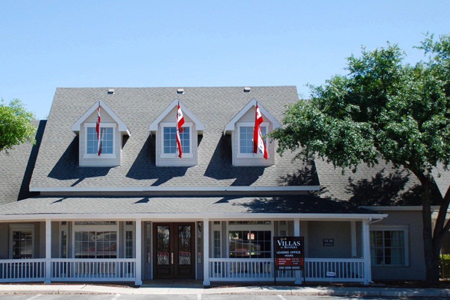 a building with three windows flags