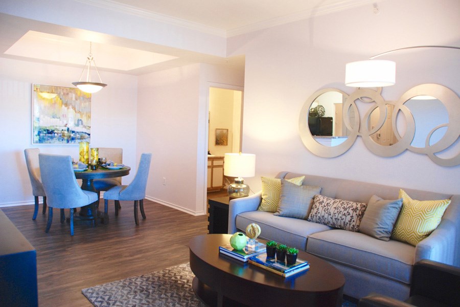 a living room and dining room with a couch and a table