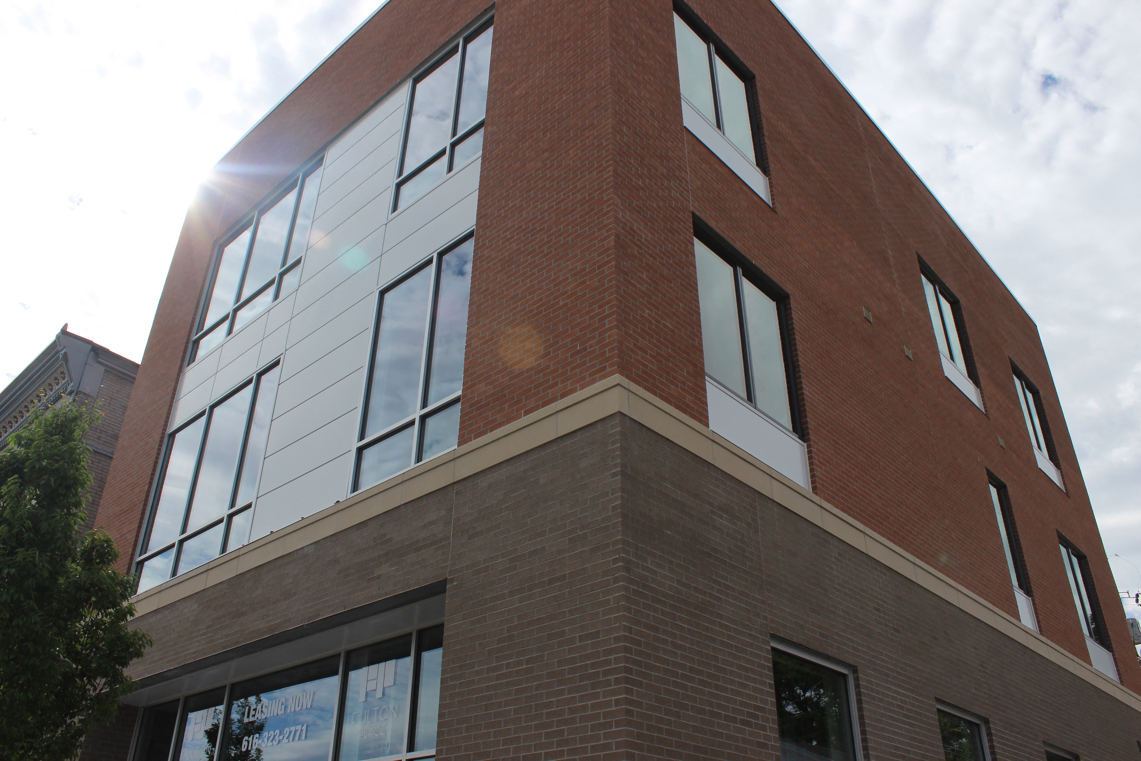 the corner of a brick building with windows