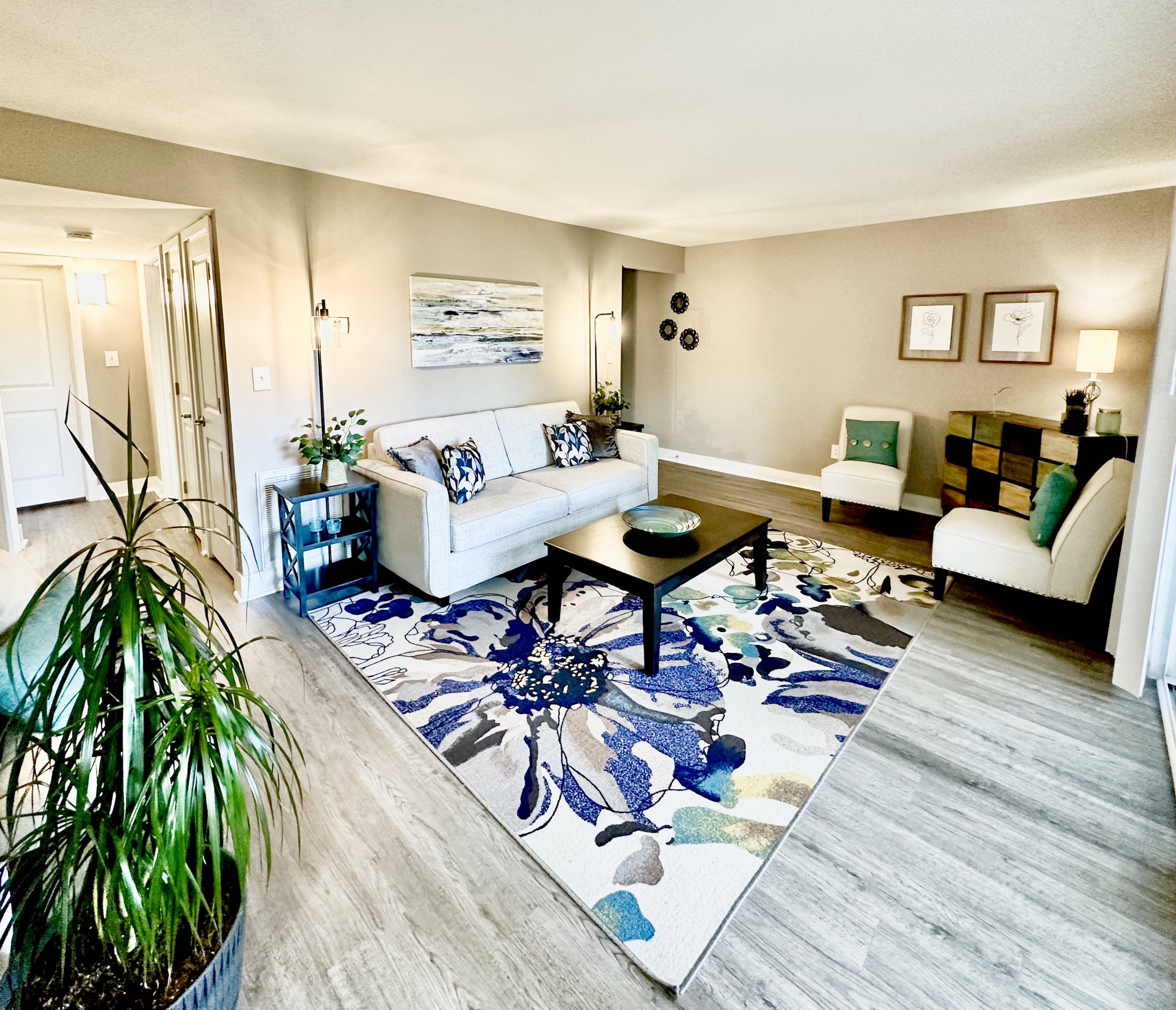 a living room with a white couch and a rug