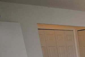 Oversized Master a bedroom with a bed and two lamps and a closet