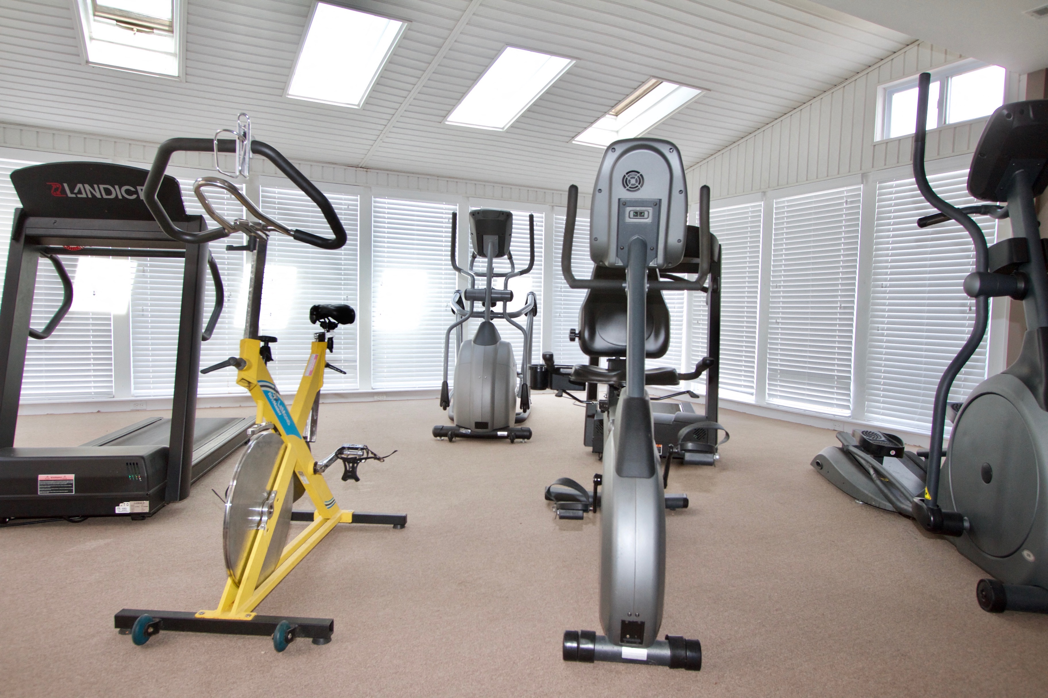 a gym with various exercise equipment in it