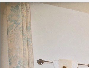 a bathroom with a toilet and a sink and a mirror
