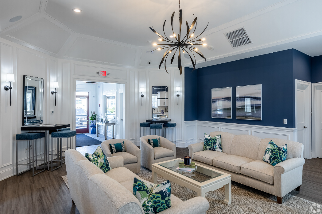 a blue and white living room with couches and a coffee table