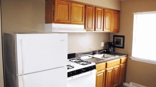 a small kitchen with a stove and a refrigerator