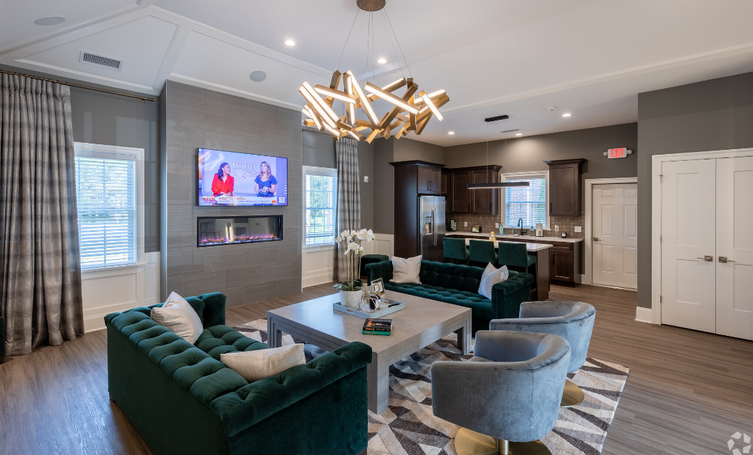 a living room with couches and chairs and a table and a television