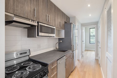a kitchen with stainless steel appliances and wooden cabinets