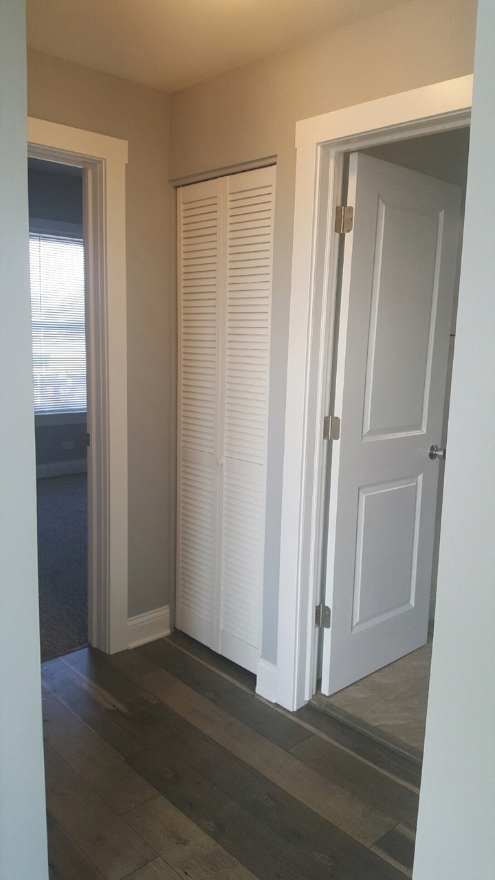 a room with a closet and a door with shutters