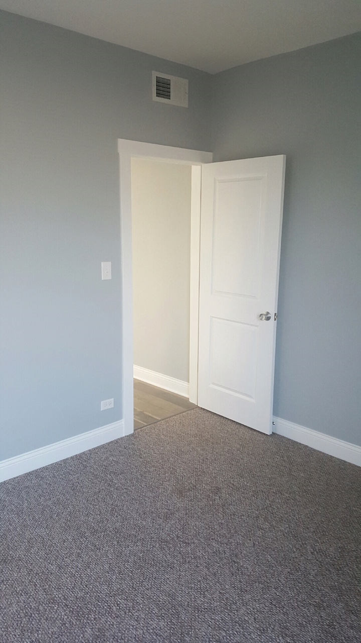 a room with blue walls and a white door