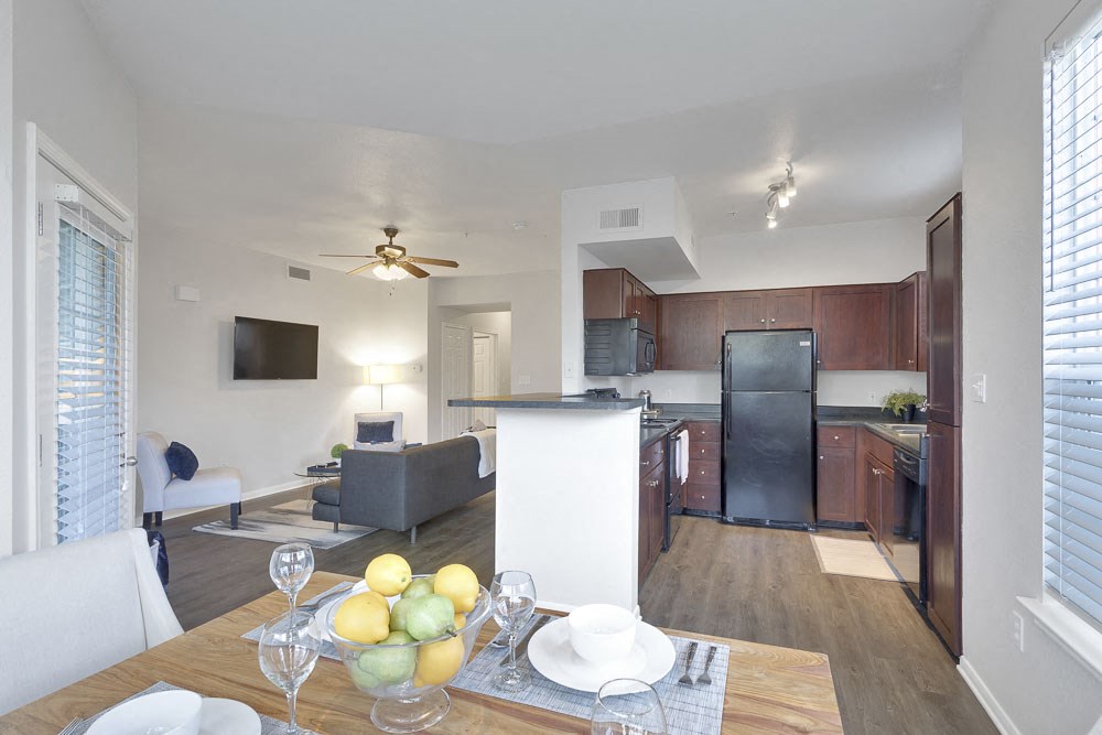 a kitchen and living room with a dining room table
