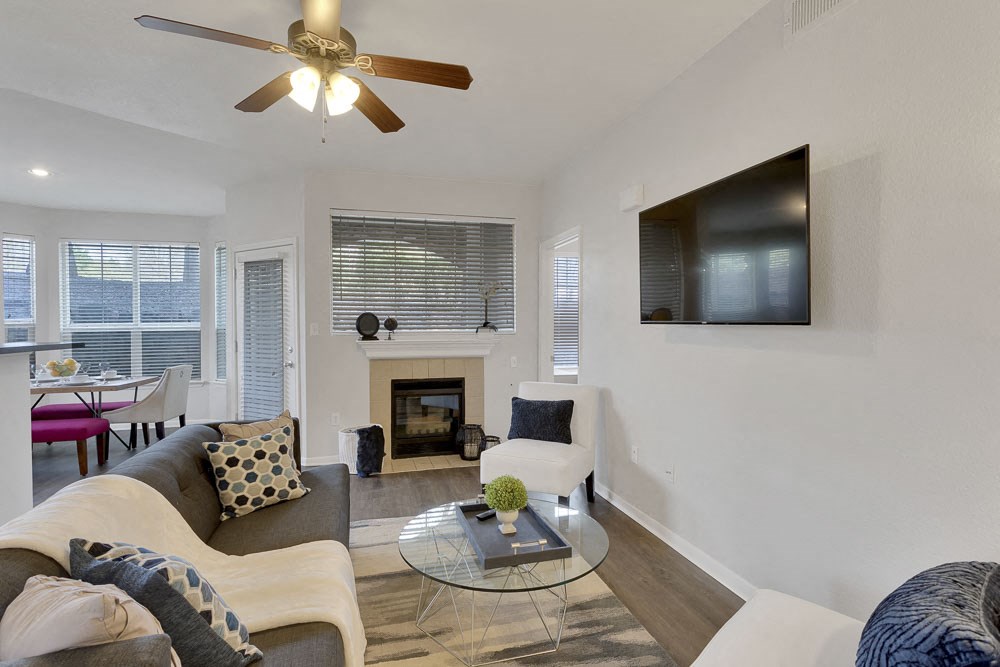 a living room with a couch and a ceiling fan