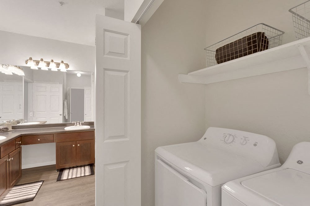 a white laundry room with a washer and dryer