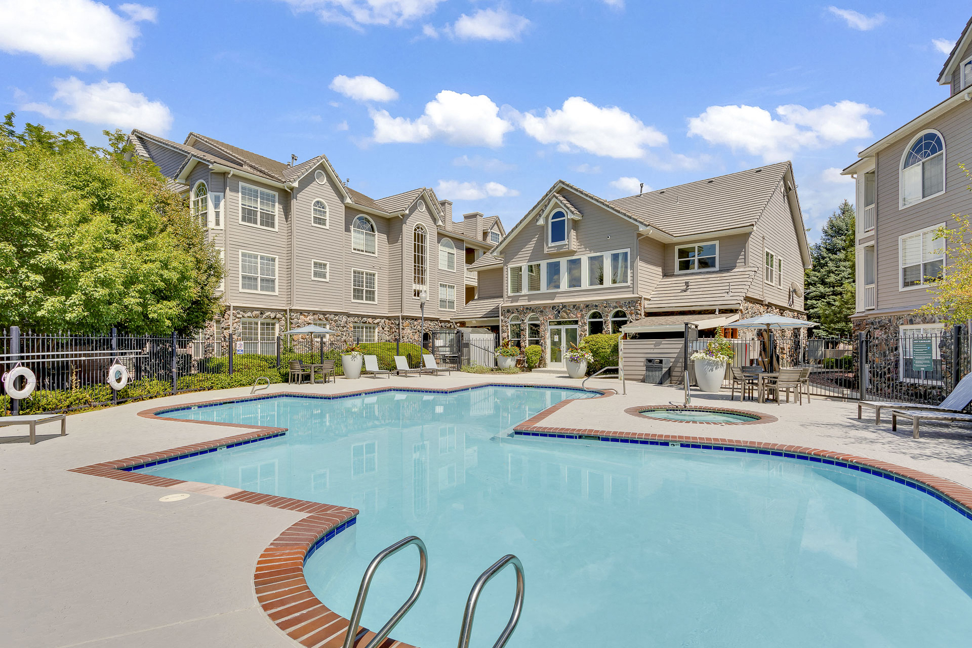 Apartment pool with lounge seating and clubhouse view