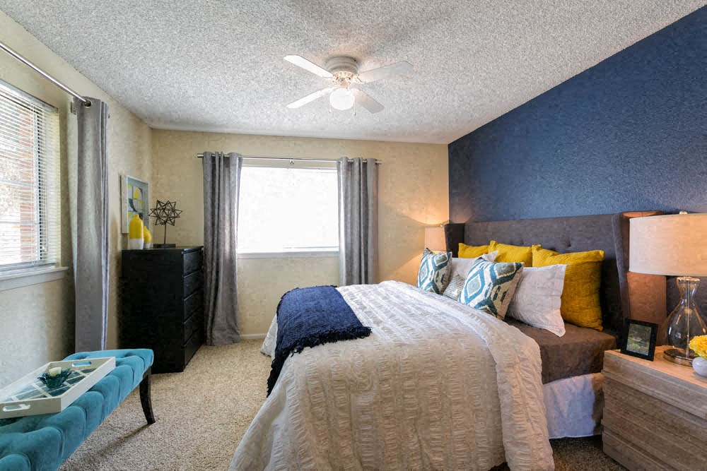 a bedroom with a bed and a ceiling fan