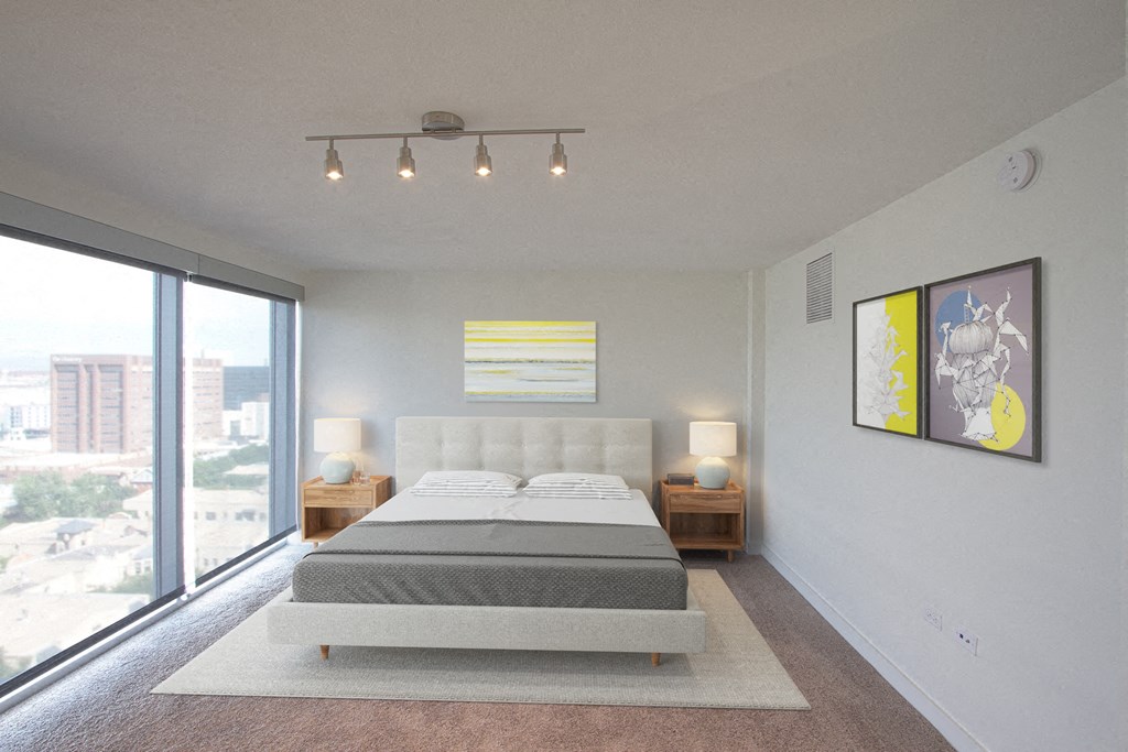 a bedroom with a bed and a large window