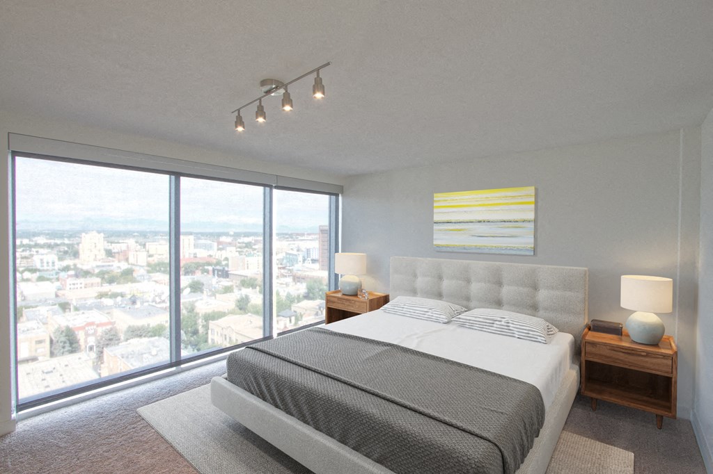a bedroom with a bed and a view of the city